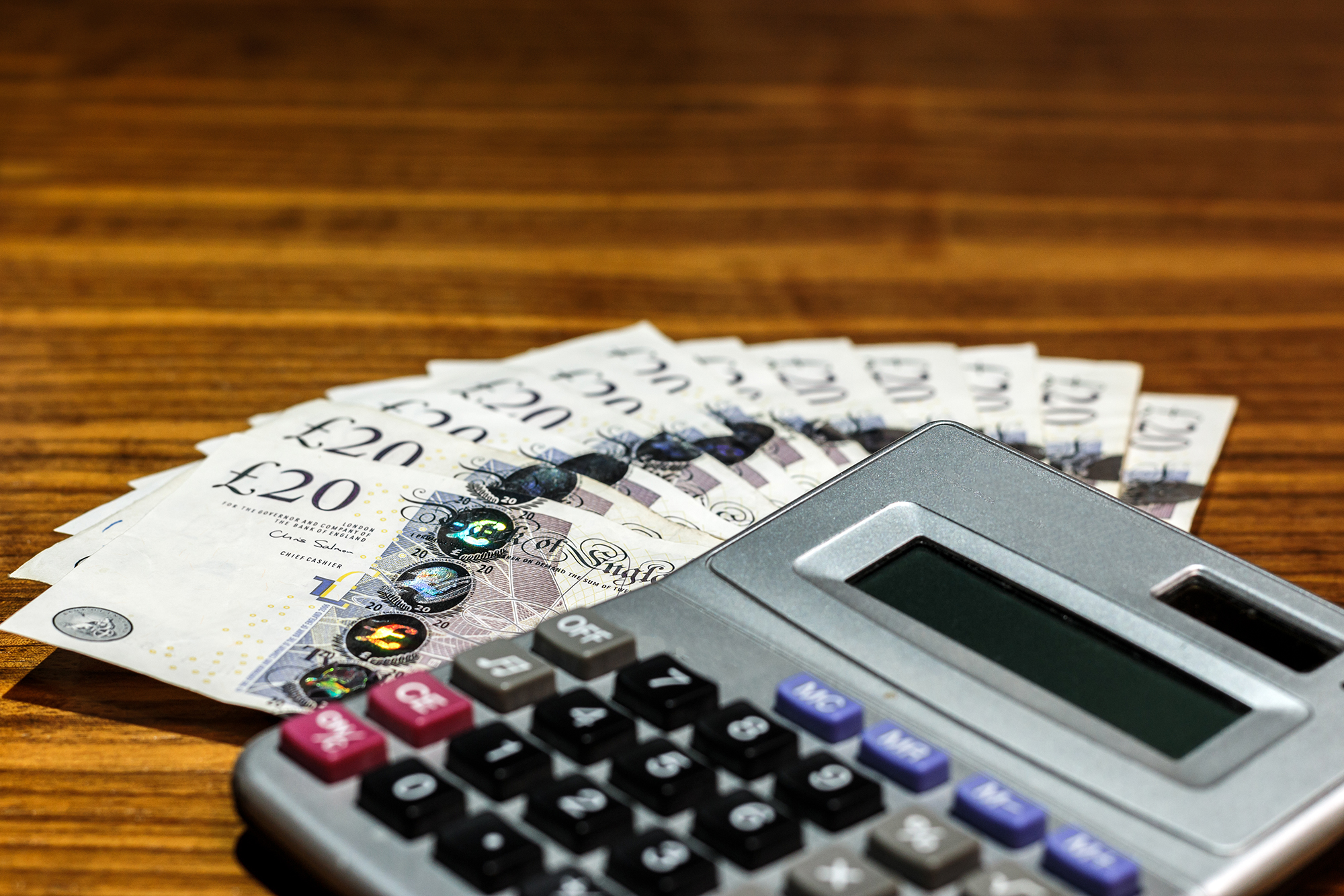 UK notes next to a calculator. (Image: Shutterstock)