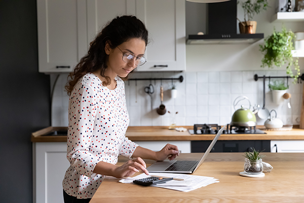Woman calculating finances. (Image: Shutterstock)