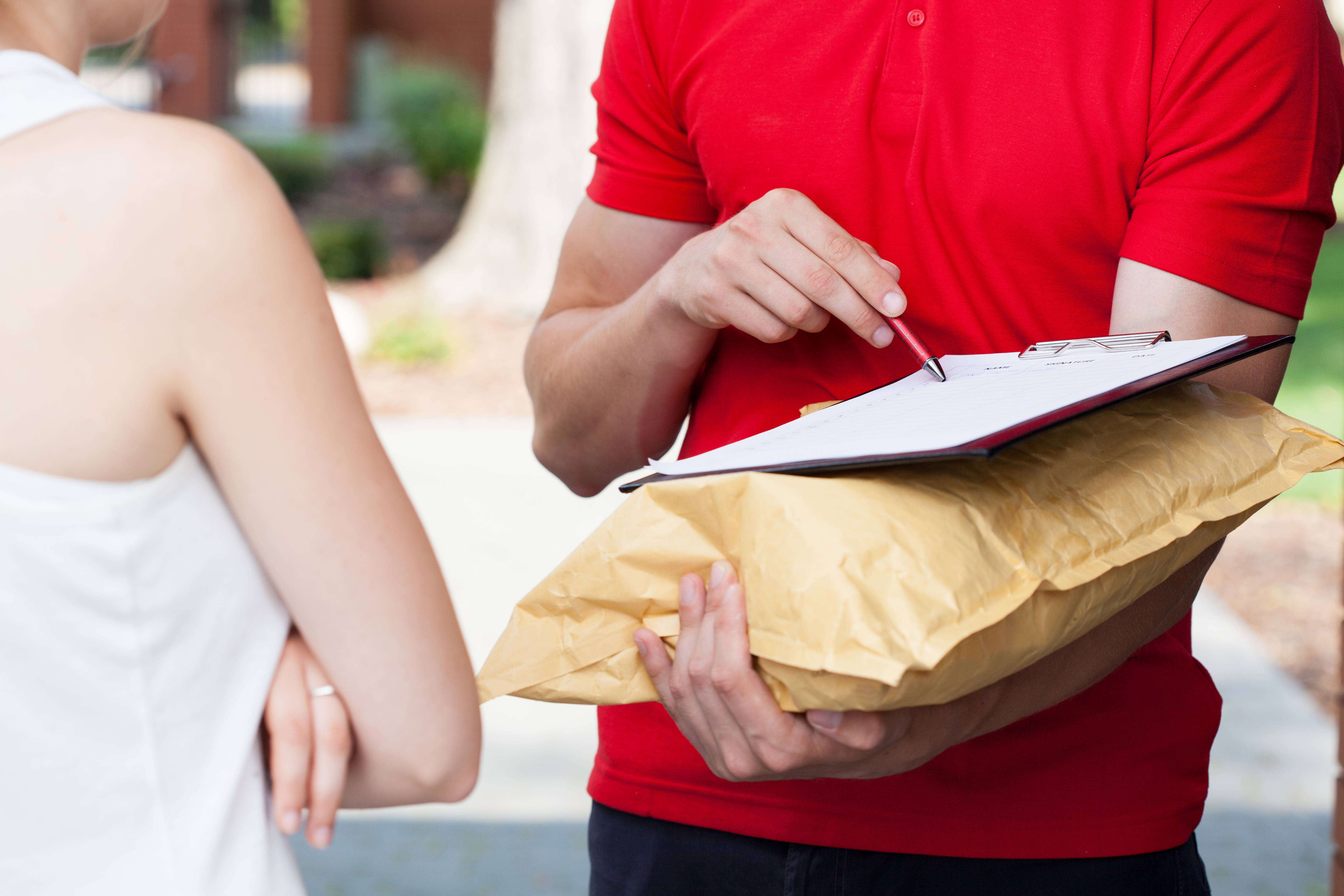 Postman getting signature. (Image: Shutterstock)