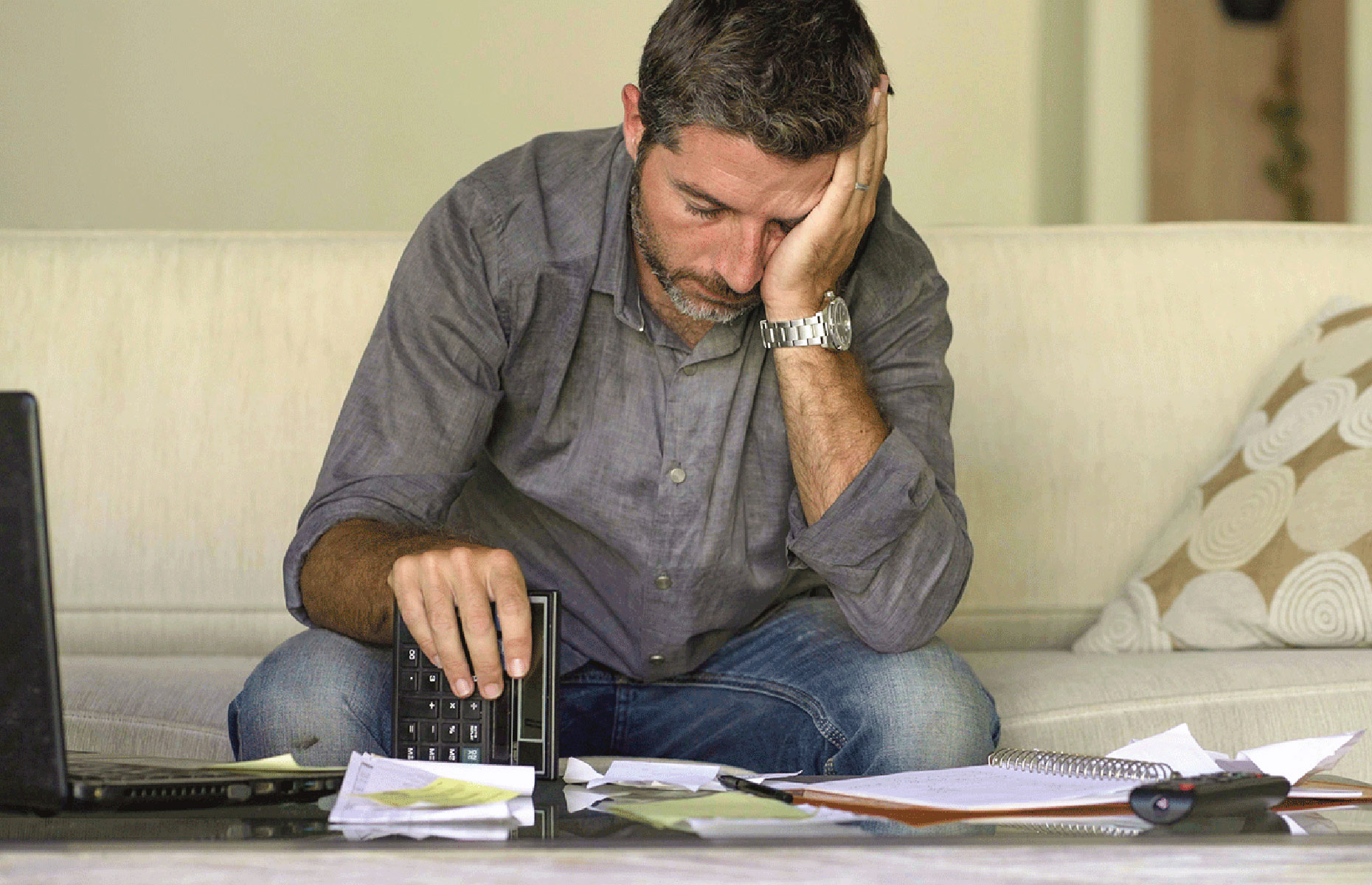 Man in grey shirt looking at mortgage papers