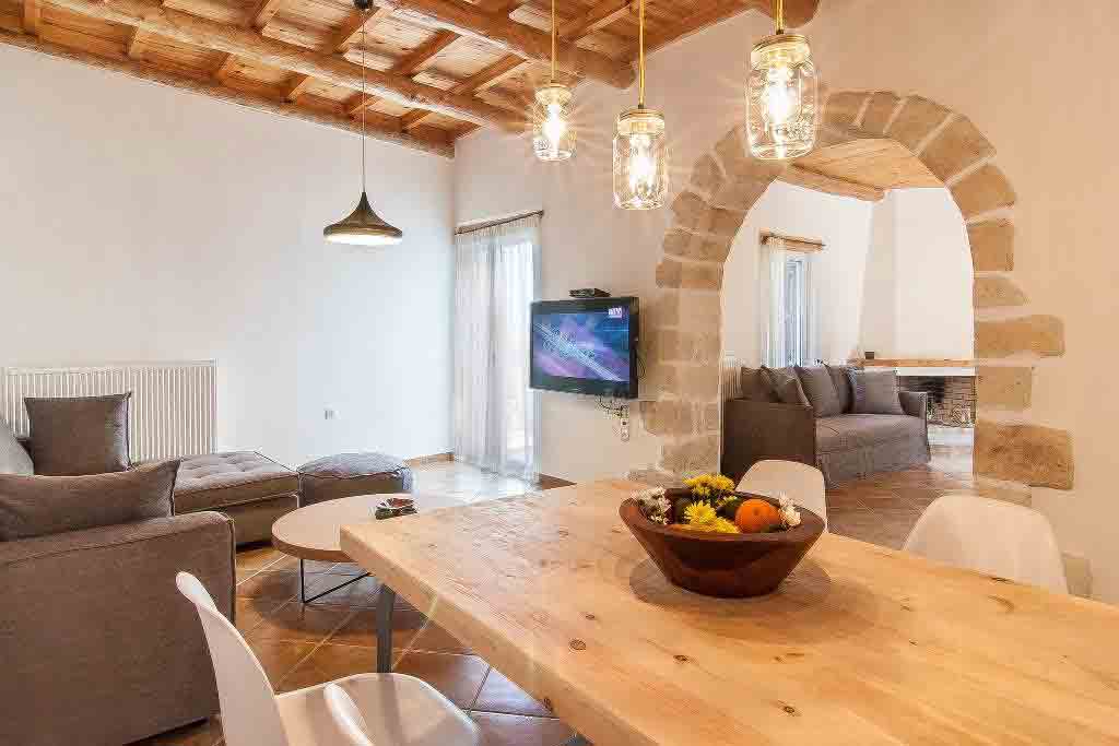 Exposed brick and a wooden coffered ceiling add character to the living spaces. Image: A Place in Crete / Rightmove