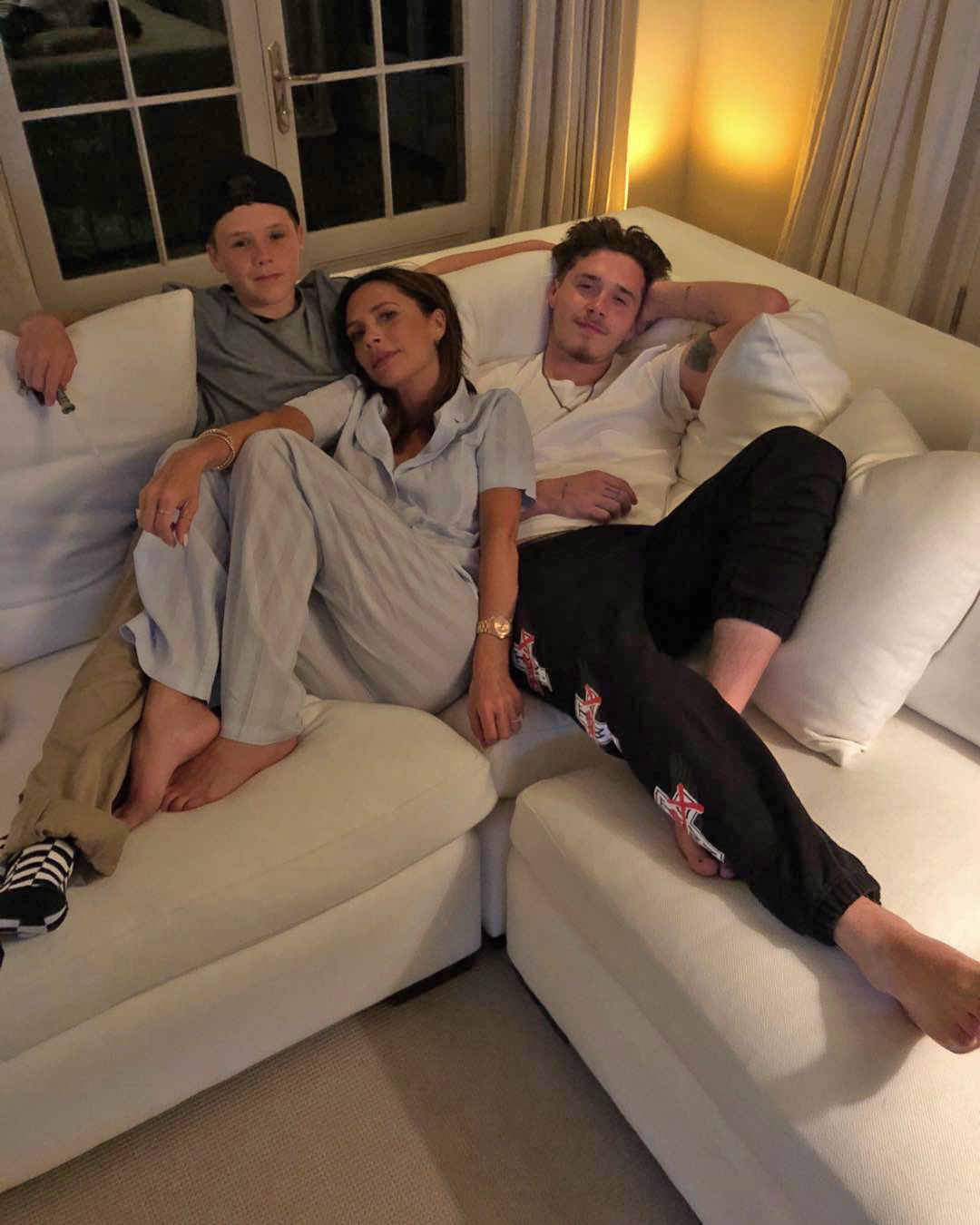 A white corner sofa is the perfect spot for the Beckham family to relax. Image: @victoriabeckham / Instagram 