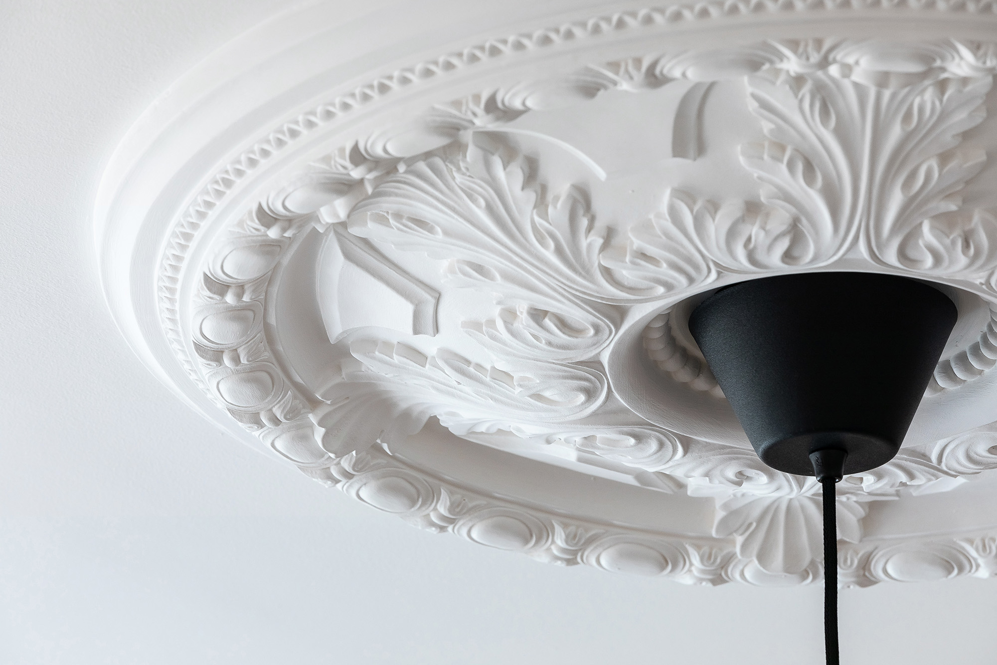 Original details like ceiling roses can add no end of character to a modern living space. Image: Create Bespoke