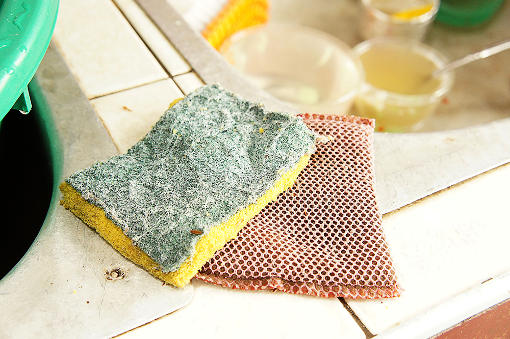 Replace your cleaning sponges every few weeks for a cleaner home. Image: girl-think-position/Shutterstock