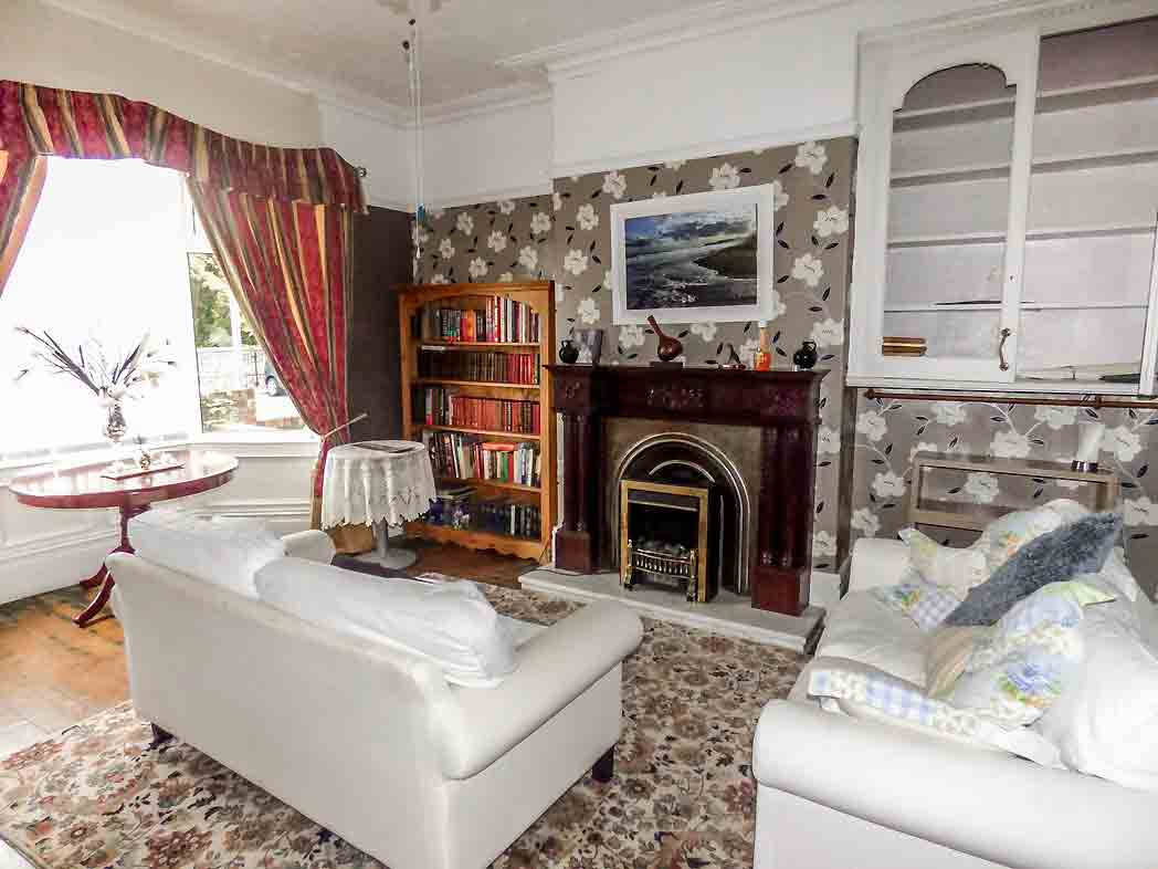 Period features abound in this living room, from the coving to the panelled bay window. Image: Pattinson